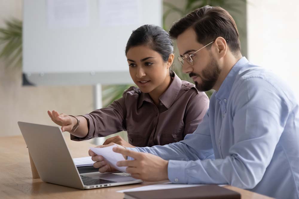 Business man and woman viewing laptop