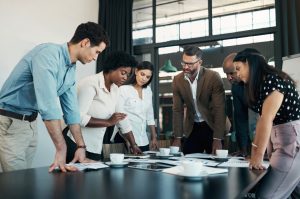 Business men and women in meeting reviewing document